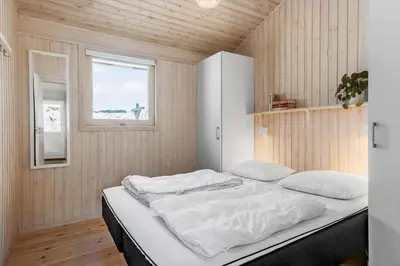 a bedroom with a bed in a room with a window at BL1620-Saltum-Foraarsvangen-7 in Saltum