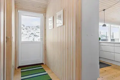 a hallway with a white door and a window at BL1620-Saltum-Foraarsvangen-7 in Saltum