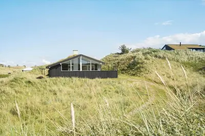 a house sitting on top of a grassy hill at BL1620-Saltum-Foraarsvangen-7 in Saltum