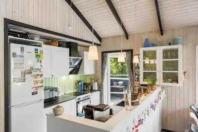 a kitchen with white cabinets and a white refrigerator at BL1666-Saltum-Vikingebanke-5 in Saltum