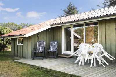 a deck with chairs and a table on a house at BL1419-Saltum-Skanderborgvej-13 in Saltum