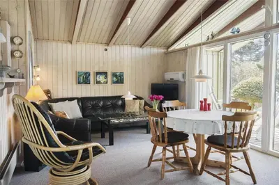 a living room with a table and chairs and a couch at BL1419-Saltum-Skanderborgvej-13 in Saltum
