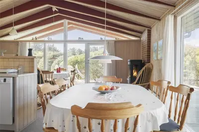 a kitchen and dining room with a table and chairs at BL1419-Saltum-Skanderborgvej-13 in Saltum