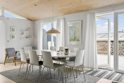 a dining room with a table and chairs at BL1156-Blokhus-Ankerhusvej-44 in Blokhus