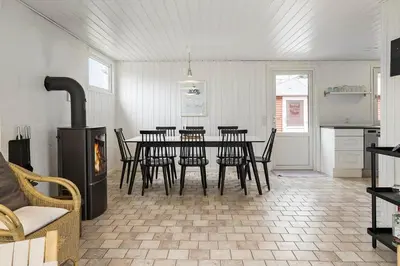 a dining room with a table and chairs in a kitchen at BL253-Blokhus-Jaegerbakken-9 in Blokhus