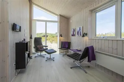 a room with chairs and a table and windows at BL117-Pandrup-Marsvinet-30 in Pandrup
