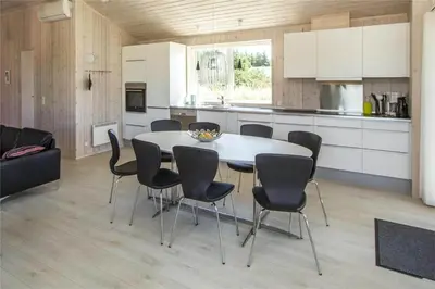 a kitchen and dining room with a table and chairs at BL117-Pandrup-Marsvinet-30 in Pandrup