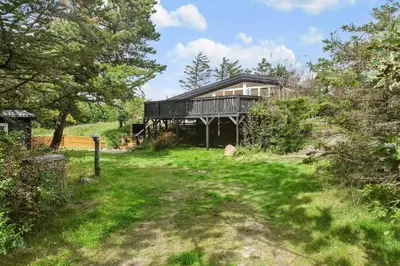 a house sitting on top of a grassy hill at BL1335-Blokhus-Havorns-Alle-32 in Blokhus