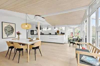 a kitchen and dining room with a table and chairs at BL1335-Blokhus-Havorns-Alle-32 in Blokhus