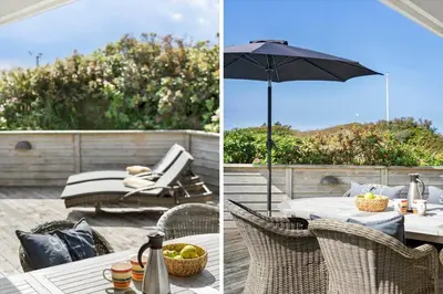 a patio with an umbrella and a table and chairs at BL1647-Saltum-Graabakken-46 in Saltum
