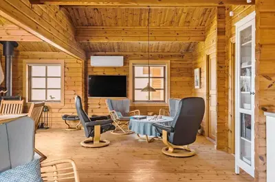 a living room with chairs and a table and a tv at BL1801-Saltum-Kordalsvej-115 in Saltum