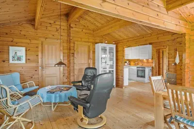 a living room with chairs and a table in a cabin at BL1801-Saltum-Kordalsvej-115 in Saltum