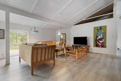 a living room with a table and a dining room at BL1200-Blokhus-Plantagevej-6-C in Blokhus