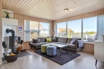 a living room with a couch and a fireplace at BL813-Blokhus-Klitvejen-12 in Blokhus