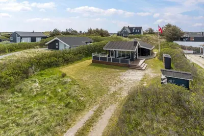 an aerial view of a house on a beach at BL813-Blokhus-Klitvejen-12 in Blokhus