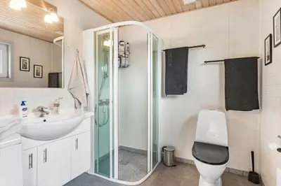 a bathroom with a shower and a toilet and a sink at BL1332-Pandrup-Rodhusparken-78 in Pandrup