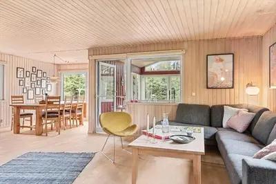 a living room with a couch and a table at BL1332-Pandrup-Rodhusparken-78 in Pandrup