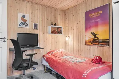 a bedroom with a desk with a computer and a chair at BL1332-Pandrup-Rodhusparken-78 in Pandrup