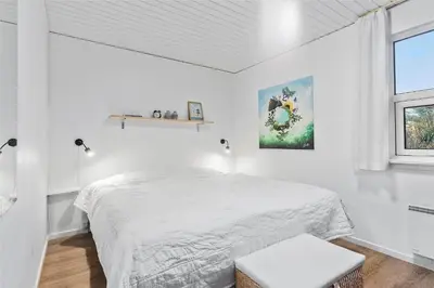 a white bedroom with a bed and a window at BL1767-Saltum-Saltum-Strandvej-209 in Saltum