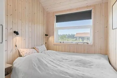 a bedroom with a bed and a window at BL806-Saltum-Laustvej-8 in Saltum