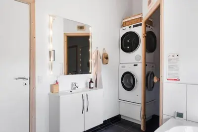 a bathroom with a washing machine and a sink at BL806-Saltum-Laustvej-8 in Saltum