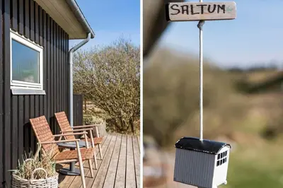 a porch with a grill and chairs and a house at BL806-Saltum-Laustvej-8 in Saltum