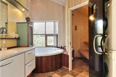 a large bathroom with a tub and a sink at BL861-Blokhus-Pirupshvarrevej-49 in Blokhus