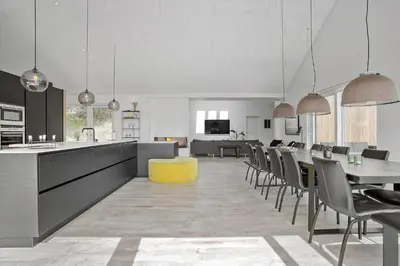 a kitchen and dining room with a long table and chairs at BL1405-Blokhus-Sletten-12 in Blokhus