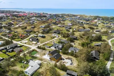 an aerial view of a suburb with houses and the ocean at BL1405-Blokhus-Sletten-12 in Blokhus