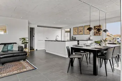 a kitchen and dining room with a table and chairs at BL1573-Blokhus-Soren-Tjenersvej-3 in Blokhus