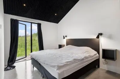 a bedroom with a bed and a large window at BL1364-Saltum-Tolhoj-34 in Saltum