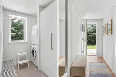 a white laundry room with a washer and dryer at BL1205-Blokhus-Quintusvej-26 in Blokhus