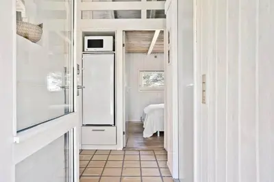 a kitchen with a white refrigerator in a room at BL583-Saltum-Saltum-Strandvej-210 in Saltum