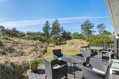 a patio with chairs and a table and a table and chairs at BL331-Saltum-Ornebjergvej-21 in Saltum