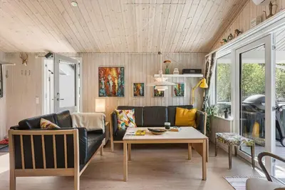 a living room with a couch and a table at BL1466-Pandrup-Lunekrogen-14 in Pandrup