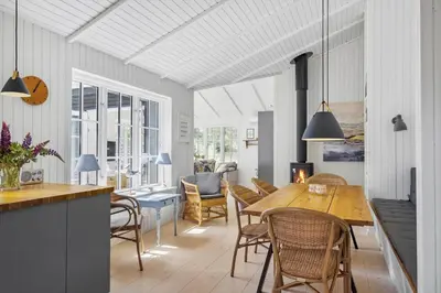 a kitchen and dining room with a table and chairs at BL1756-Blokhus-Bregnehojvej-7-A in Blokhus