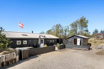 a house with a flag on top of it at BL1601-Blokhus-Kristinesvej-15 in Blokhus