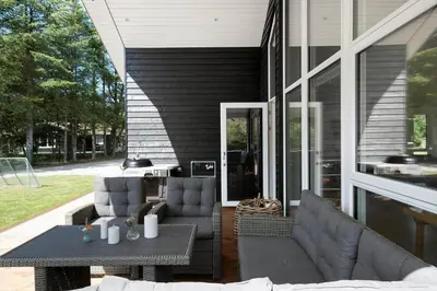 a patio with two couches and a table and chairs at BL1762-Blokhus-Bloksbjerg-22 in Blokhus