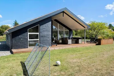 a small house with a soccer ball in the grass at BL1762-Blokhus-Bloksbjerg-22 in Blokhus