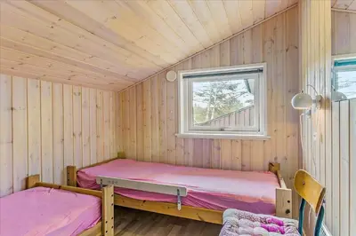 two beds in a room with a window at BL1715-Saltum-Kvansletten-15 in Saltum