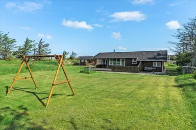 a swing set in a yard in front of a house at BL1715-Saltum-Kvansletten-15 in Saltum