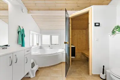 a white bathroom with a tub and a sink at BL1715-Saltum-Kvansletten-15 in Saltum