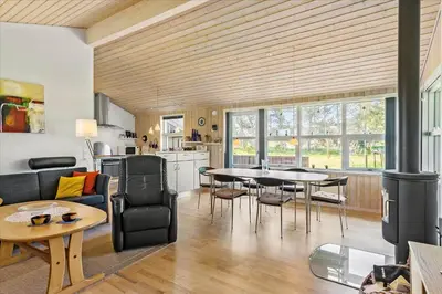 a kitchen and living room with a table and chairs at BL1715-Saltum-Kvansletten-15 in Saltum