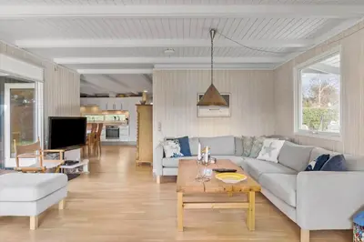 a living room with a couch and a table at BL1152-Blokhus-Septimusvej-28 in Blokhus