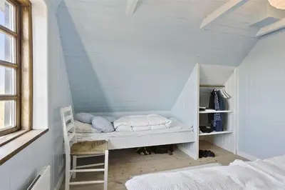 a room with a bunk bed in a attic at BL982-Pandrup-Hunetorp-Klitvej-156 in Pandrup