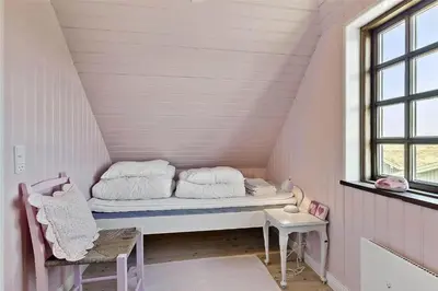 a small room with a bed in a attic at BL982-Pandrup-Hunetorp-Klitvej-156 in Pandrup