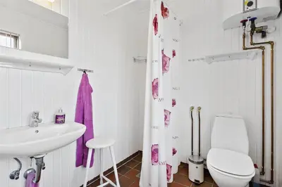 a white bathroom with a sink and a toilet at BL982-Pandrup-Hunetorp-Klitvej-156 in Pandrup