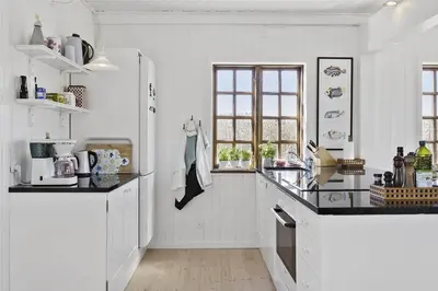 a kitchen with white walls and a black counter top at BL982-Pandrup-Hunetorp-Klitvej-156 in Pandrup