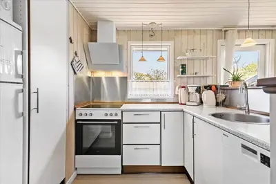 a kitchen with white cabinets and a stove top oven at BL411-Pandrup-Hunetorp-Klitvej-223 in Pandrup