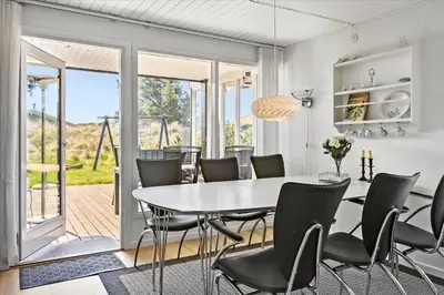 a dining room with a table and chairs at BL411-Pandrup-Hunetorp-Klitvej-223 in Pandrup